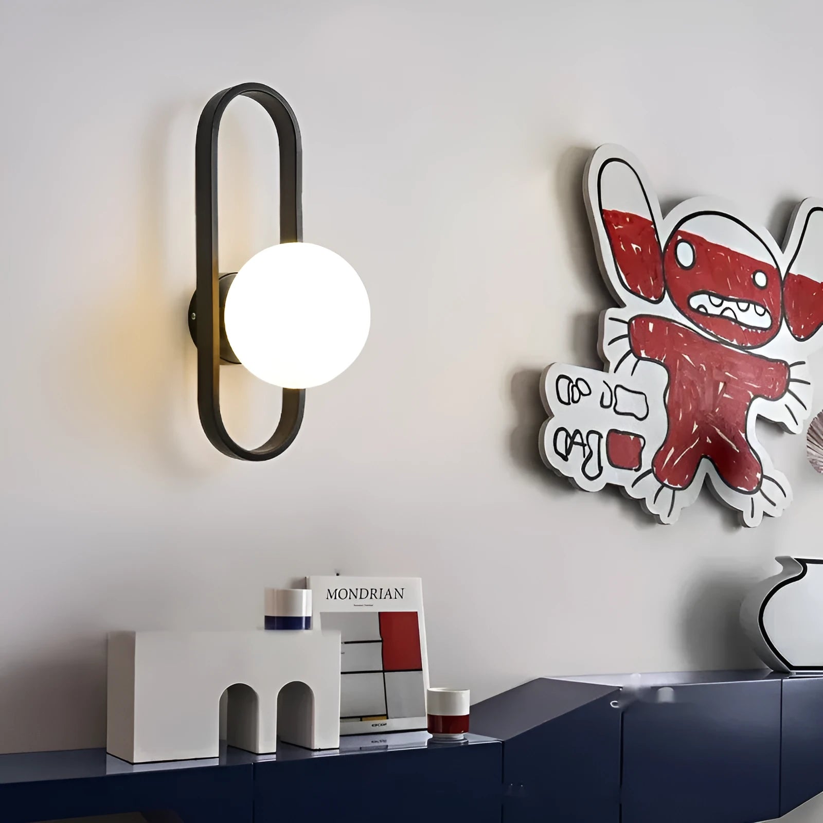 Minimalist wall-mounted lamp with glass shade and iron body in black or gold finish, showing 12W tri-colour LED light.