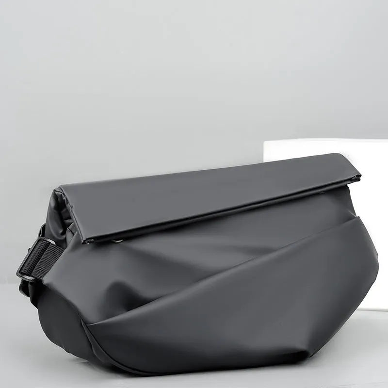 Grey crossbody bag for men showing horizontal square shape, shoulder strap, and zipper opening