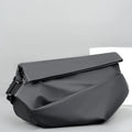 Grey crossbody bag for men showing horizontal square shape, shoulder strap, and zipper opening