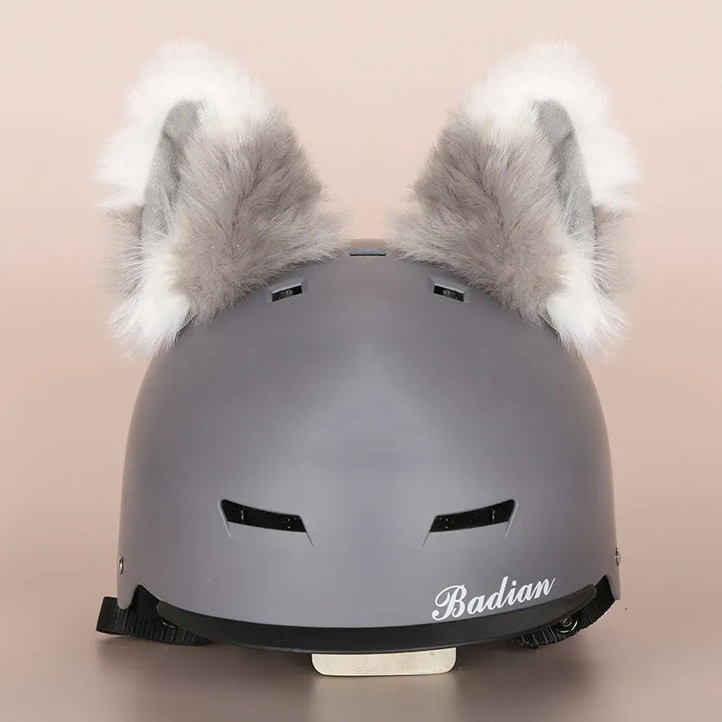 Colourful plush cartoon hat decoration sitting on top of a ski helmet