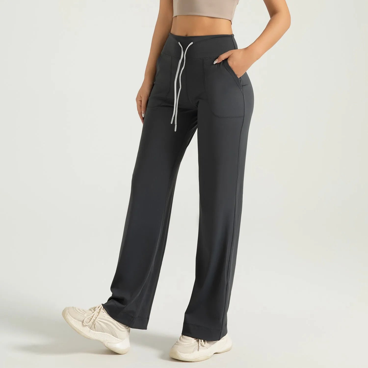 Women's high waist loose fit drawstring sports trousers in Star Black, side view, with elastic waistband and straight leg.