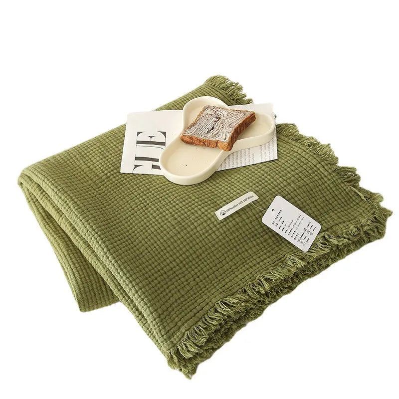 Four-layer gauze cotton blanket with tassel trim in a choice of ten colours and two sizes.