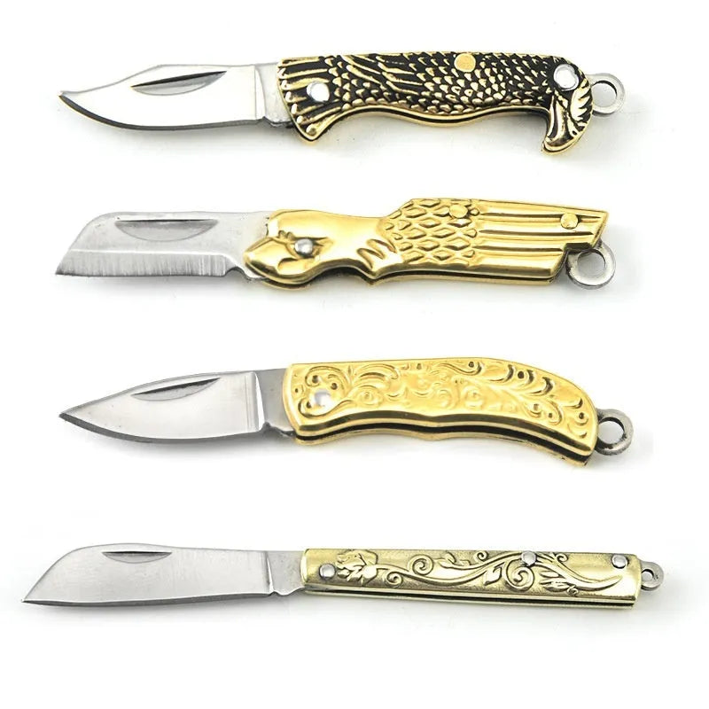 Brass mini folding knife keychain pendant with 3cm blade open showing brass body and compact size