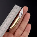 Brass mini folding knife keychain pendant with 3cm blade open showing brass body and compact size