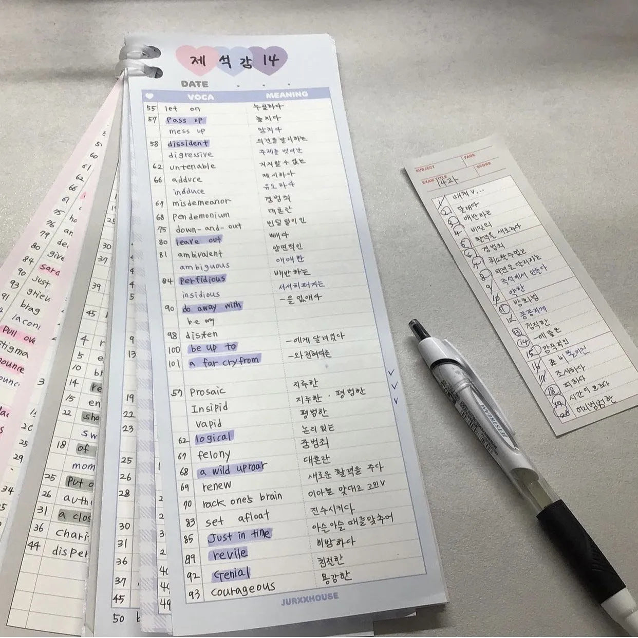 Half-B5 size vertical notepad with coloured cover, shown open to show lined pages.