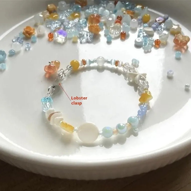 Orange sea colour summer bracelet with diamond shape and round mixed-material elements on wrist