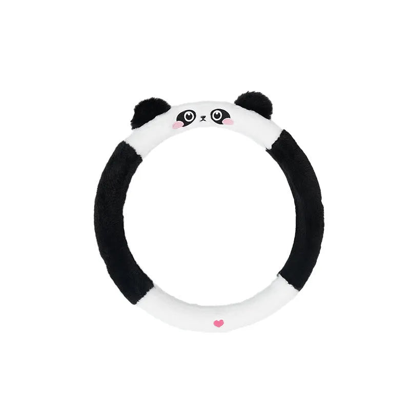 Plush furry steering wheel cover with embroidered panda face, fitted on a car steering wheel.