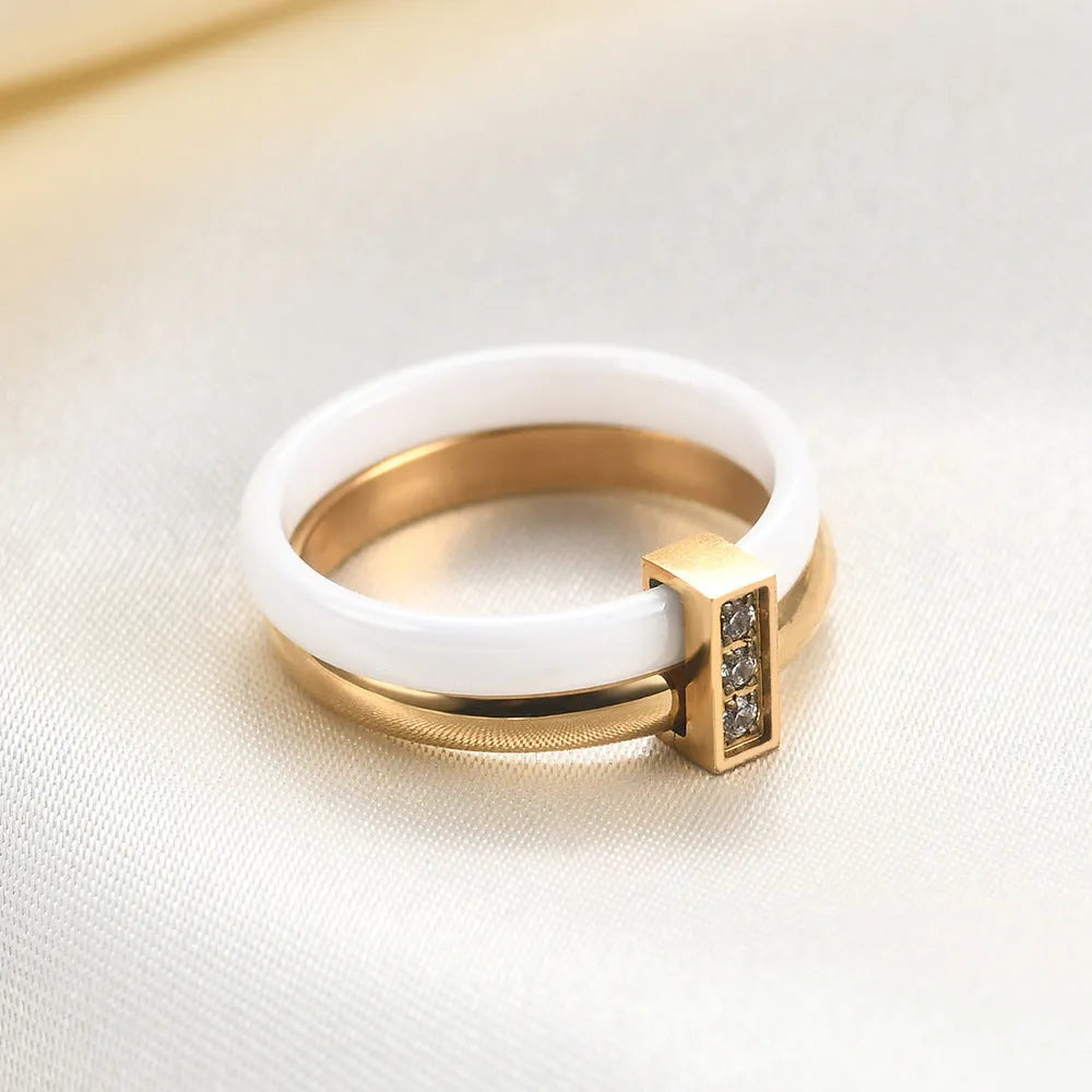 Steel black zirconium ceramic women's ring with 6mm wide band and glossy round inlay detail on a finger.