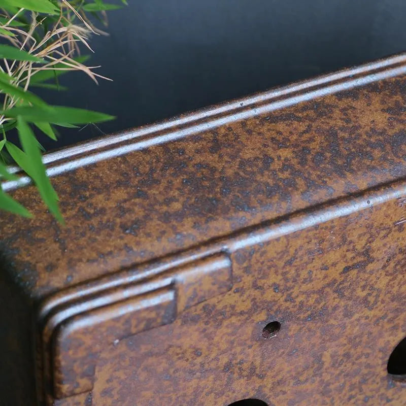 Rectangular purple sand bonsai pot with shallow basin, shown empty on a wooden surface.