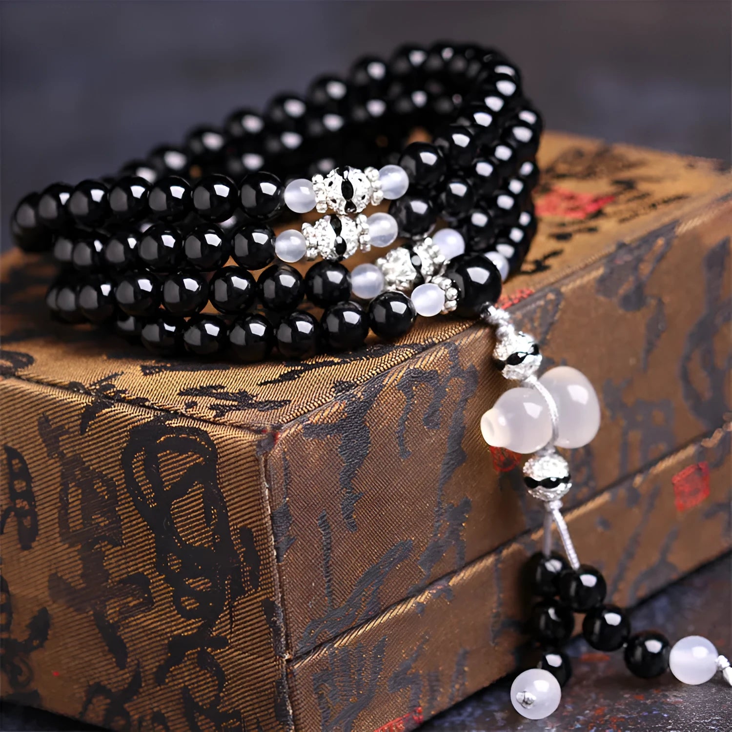 Natural black and red agate 108-bead bracelet with geometric shapes