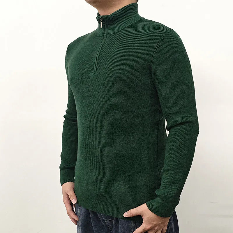 Man wearing a grey half-turtleneck zip-front sweater, a cotton blend pullover for casual wear.
