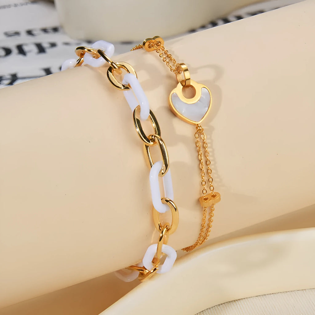 Women's adjustable stainless steel bracelet with a double-layered resin heart charm.