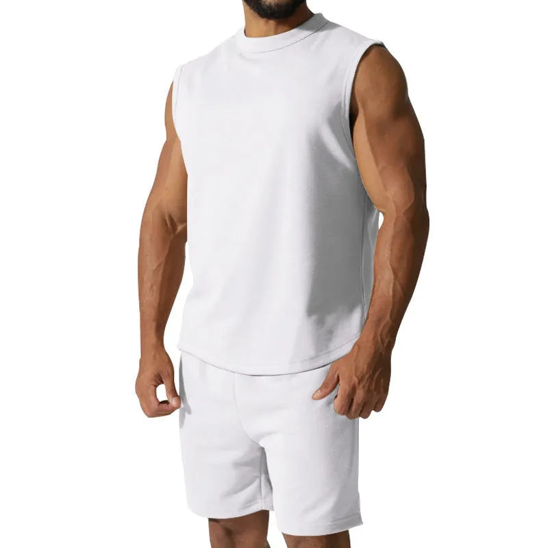 Men's sleeveless cotton blend sports top and matching shorts in a solid colour, laid flat.