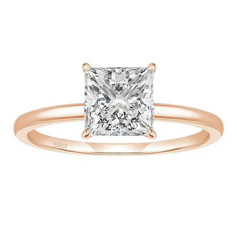 A simple geometric sterling silver ring with a round zirconia stone, shown in silver, gold, and rose gold finishes.