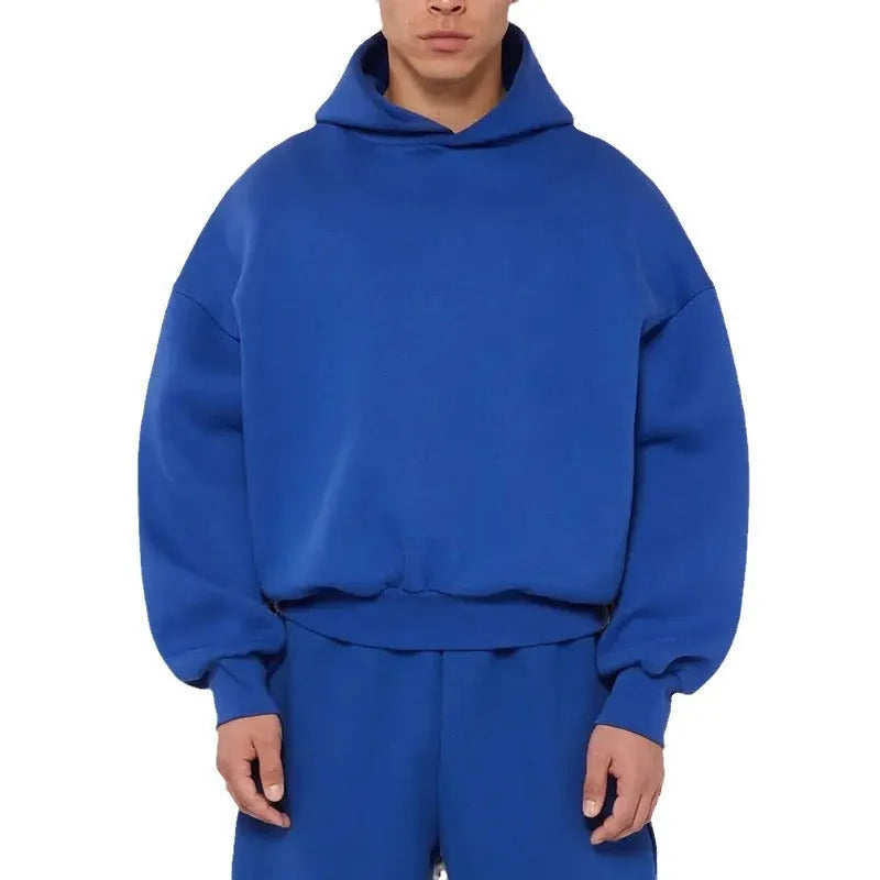 A man wearing a grey fleece-lined cotton pullover hoodie with a wool lining.