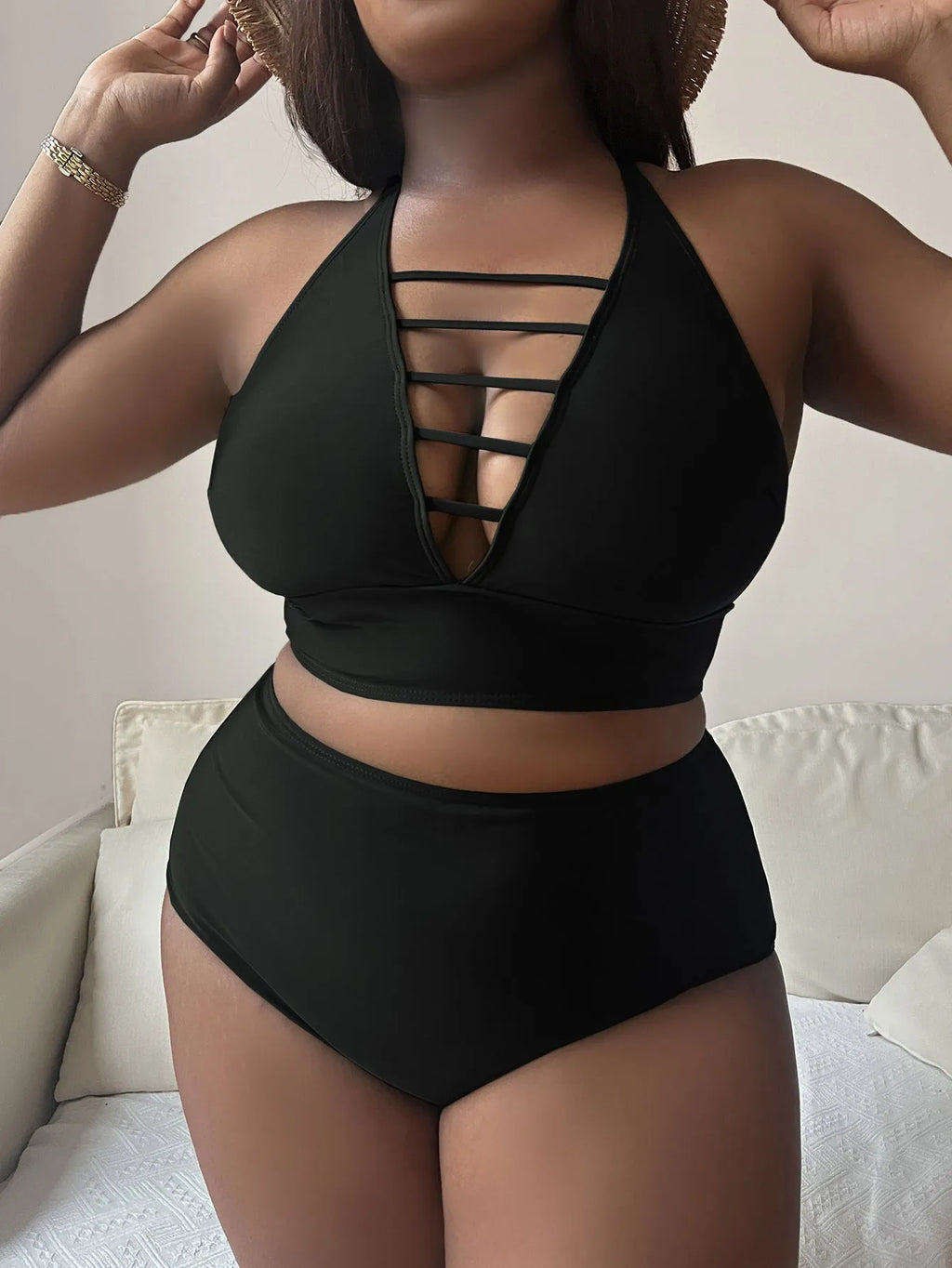 Plus size woman in a solid colour halterneck bikini with adjustable cross-back straps.