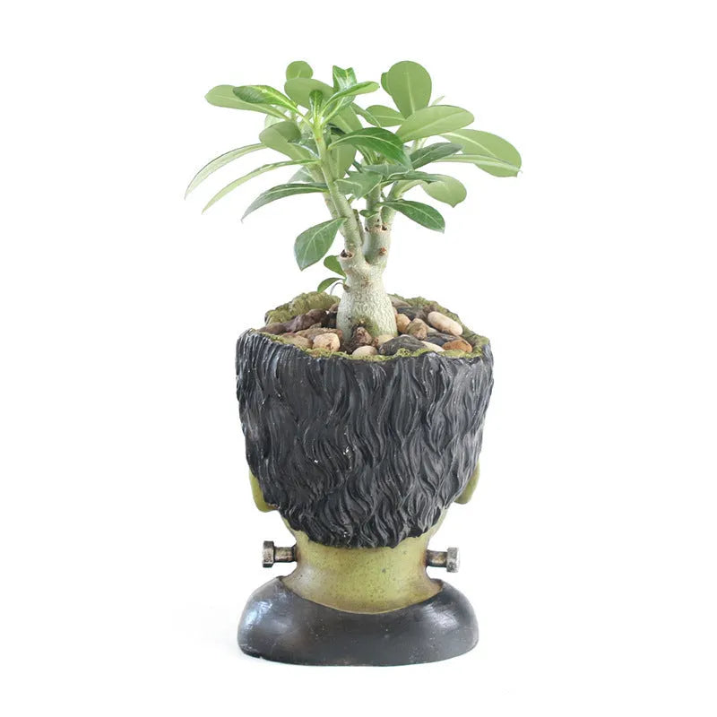 Green personalized resin flower pot with Frankenstein container design and drainage holes for desktop plant display