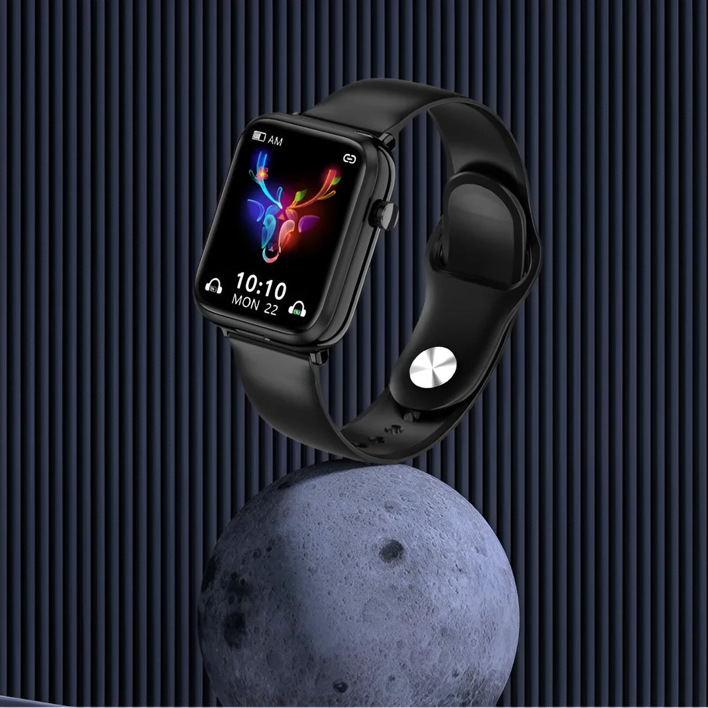 Black smartwatch with touchscreen on wrist next to its open magnetic charging case holding two wireless earbuds.