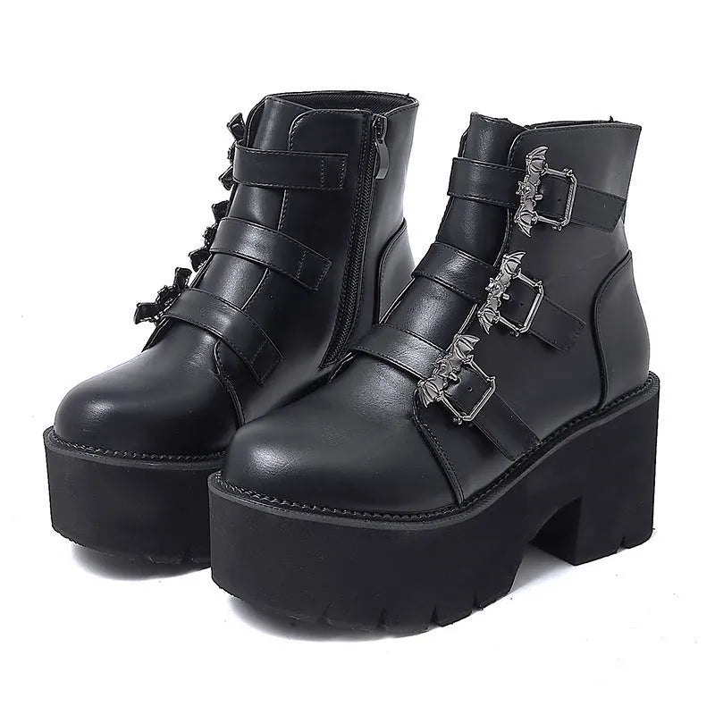 Black women's punk gothic ankle boots with a bat buckle and side zipper on a thick sole.