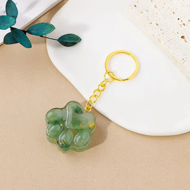 Small natural crystal cat's paw pendant on a metal keyring, available in various stone colours.