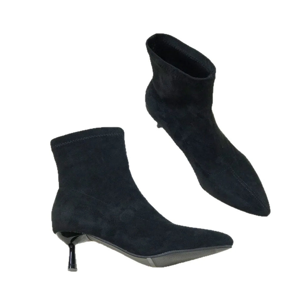Black pointed toe women's ankle boots with a stiletto heel on a mid-calf shaft.