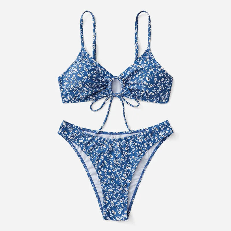 Blue women's swimsuit three-piece set featuring a top and shorts, made from polyester fabric.