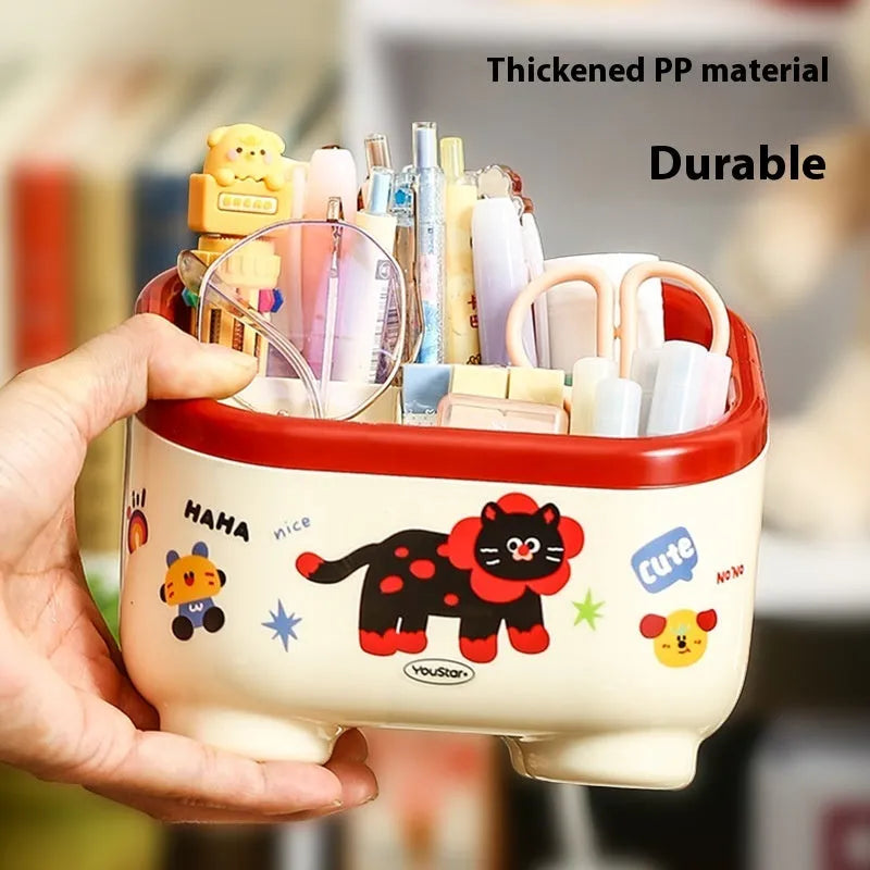 Cartoon-style plastic desktop organiser with grid compartments and red or brown stickers.