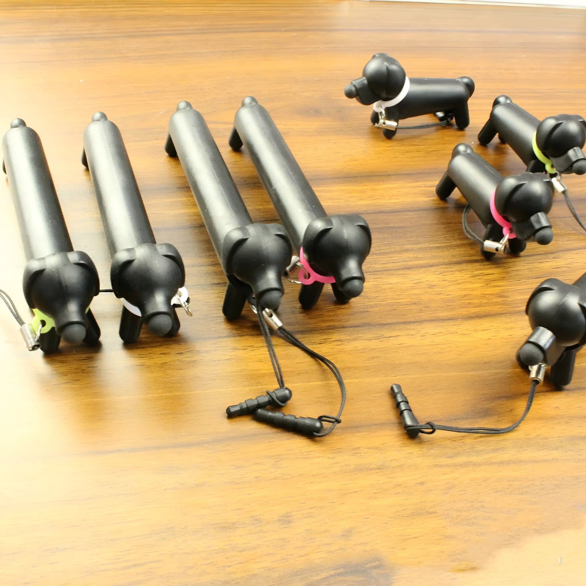 Black dog-shaped touch screen stylus showing phone holder conversion and length adjustment