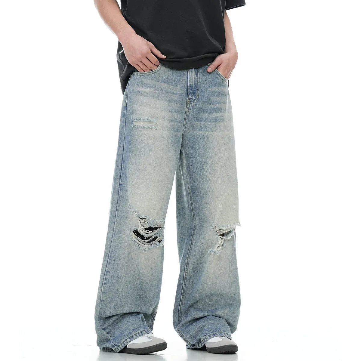 Men's blue straight-leg jeans with distressed ripped details and a zipper fly.