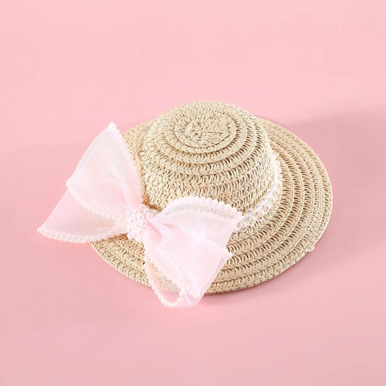 Pink pearl bow woven straw hat for a cat, shown in size S (13cm) on a mannequin head.