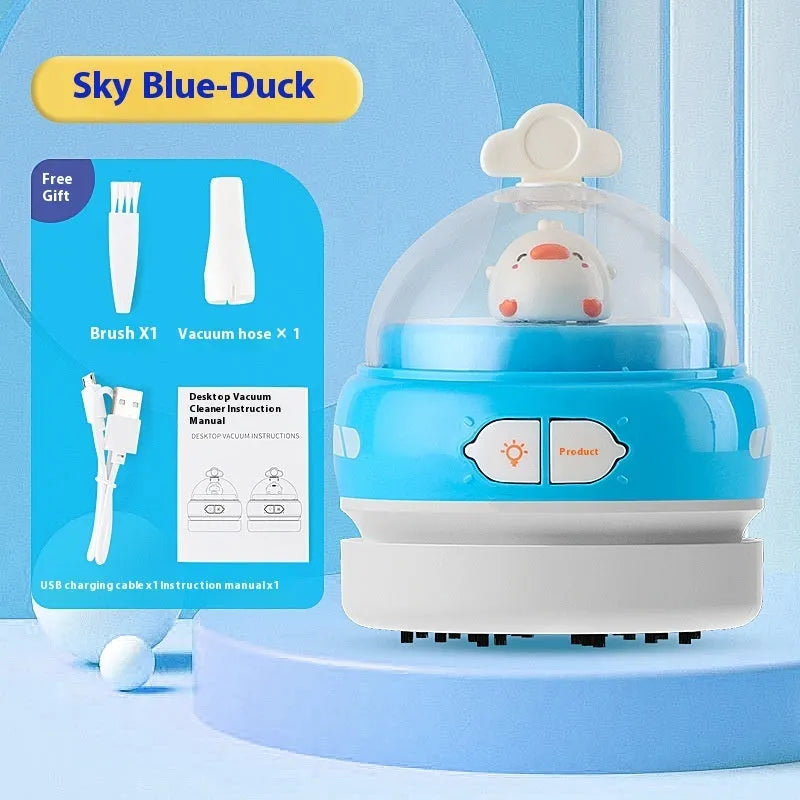 USB-powered handheld desktop vacuum cleaner in blue rocket design on a wooden desk.