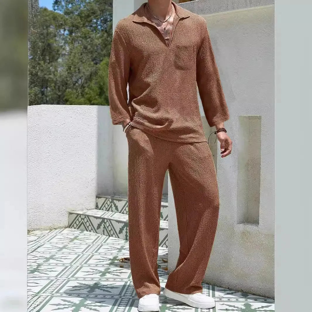 Man wearing a casual lake blue polyester shirt and matching trousers from a two-piece suit set.