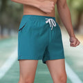Man wearing black high-waist fitness training shorts made from thin, stretchy polyester fabric.