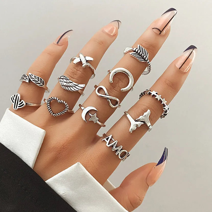 Alloy ring set with butterfly and snake retro geometric designs on display