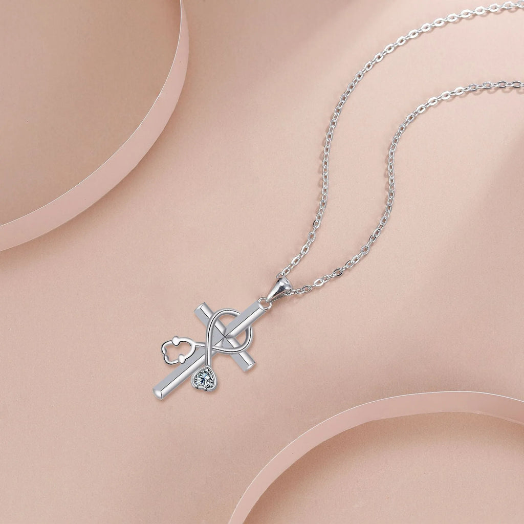 Copper cross stethoscope pendant necklace on a cross chain for women.