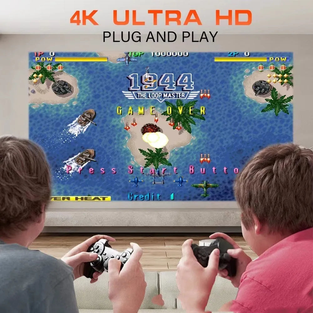 A wireless home projector with a handheld remote on a table, set up for big-screen gaming or movie viewing.