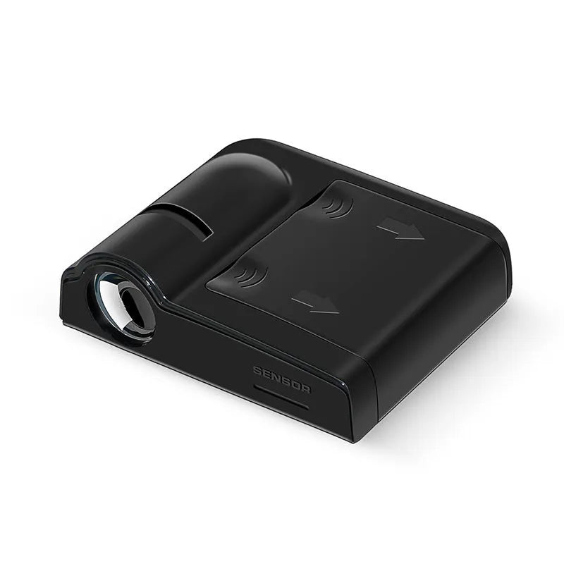 Small black car projection lamp showing front design and battery compartment, next to AA batteries for scale.