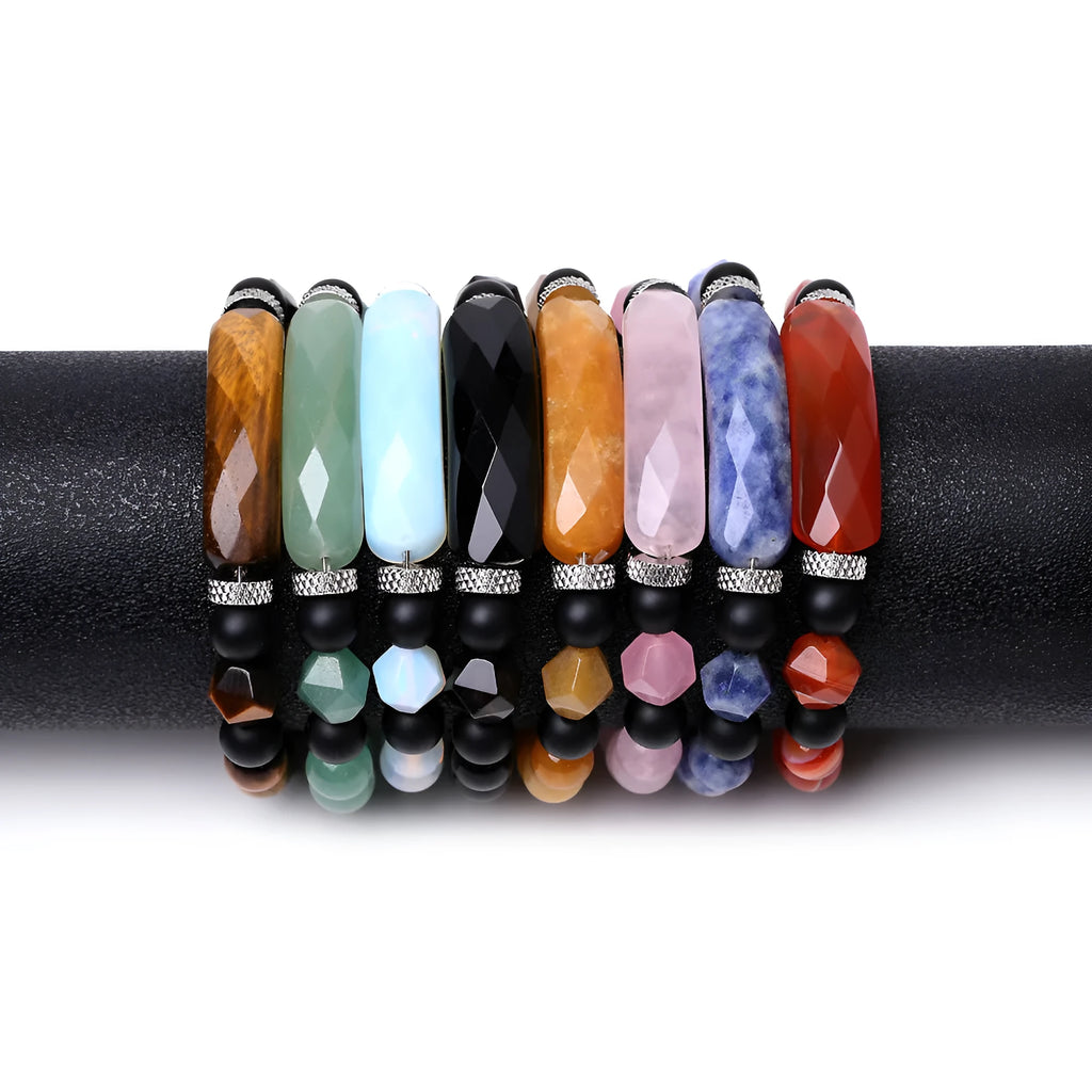 Close-up of a handmade diamond-cut black agate bracelet with geometric, fan-shaped design elements.