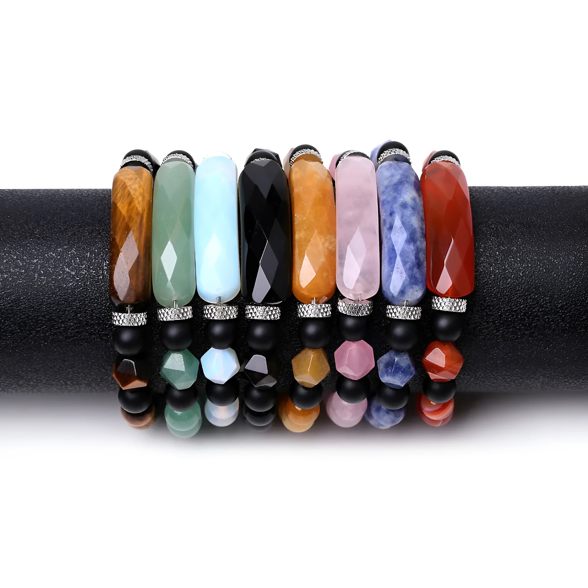 Close-up of a handmade diamond-cut black agate bracelet with geometric, fan-shaped design elements.