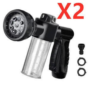 Green high-pressure foam spray gun with adjustable nozzle and attached water hose for car and garden cleaning.