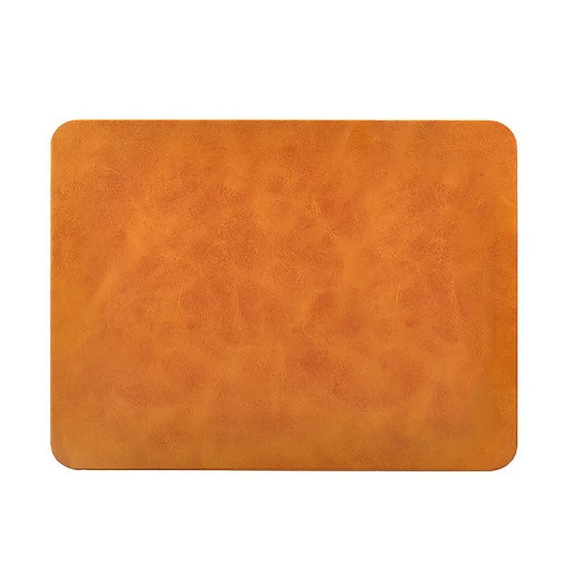 Brown leather-textured wireless charging mouse pad with a smartphone placed on it, showing a Micro USB port on the side.