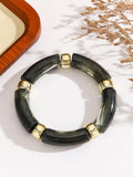 Acrylic bent tube bracelet in selected colour, lightweight and adjustable design.