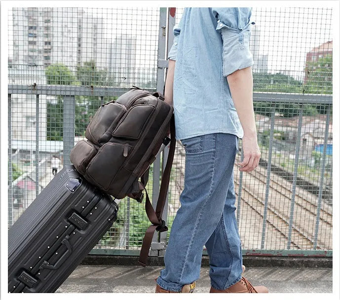 Dark brown Retro Crazy Horse leather backpack for men with a 17-inch laptop compartment open.