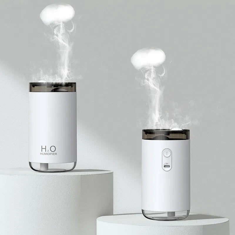 White jellyfish humidifier emitting smoke ring mist with warm night light on a desk