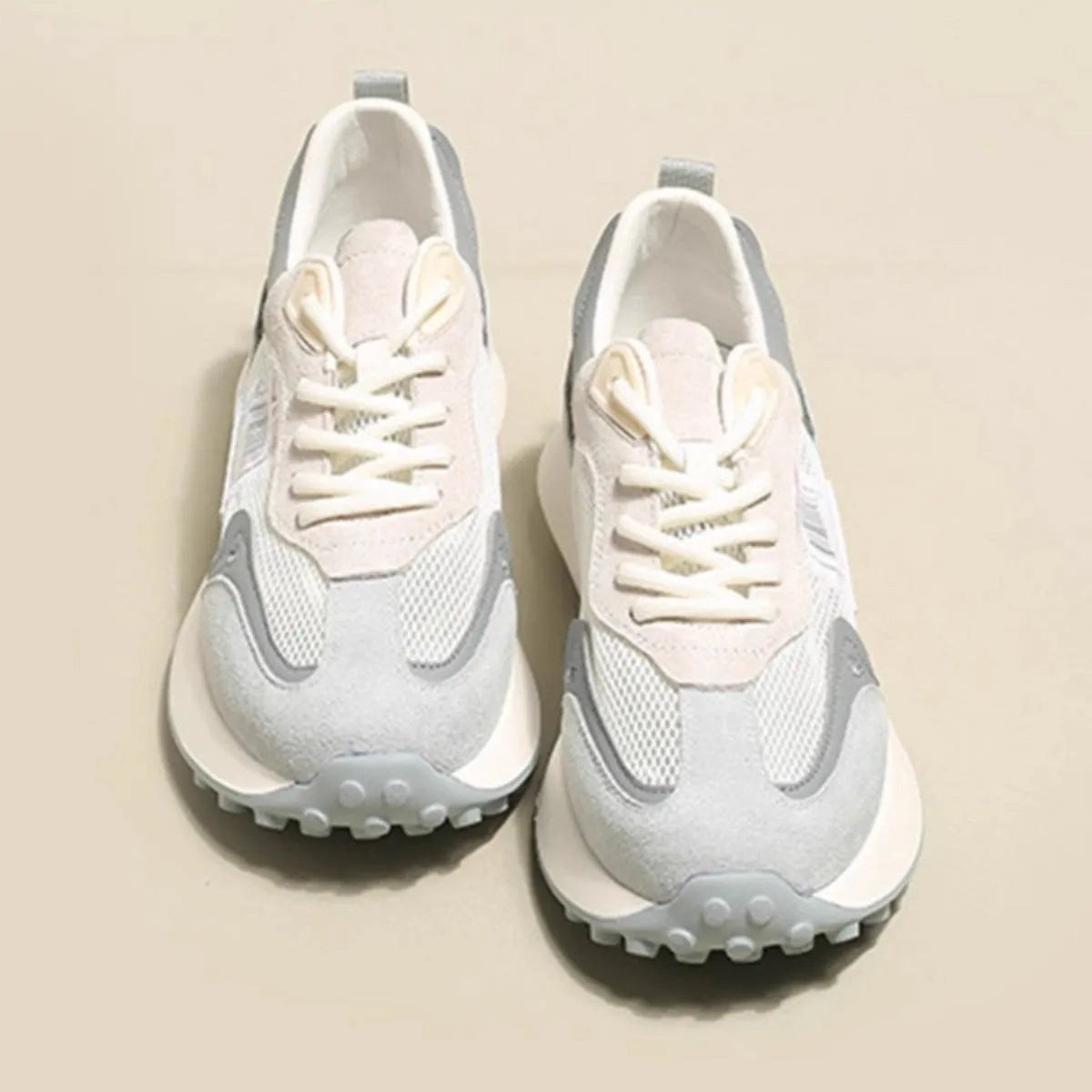 Women's grey and pink retro sneaker with low-top design and flat rubber sole
