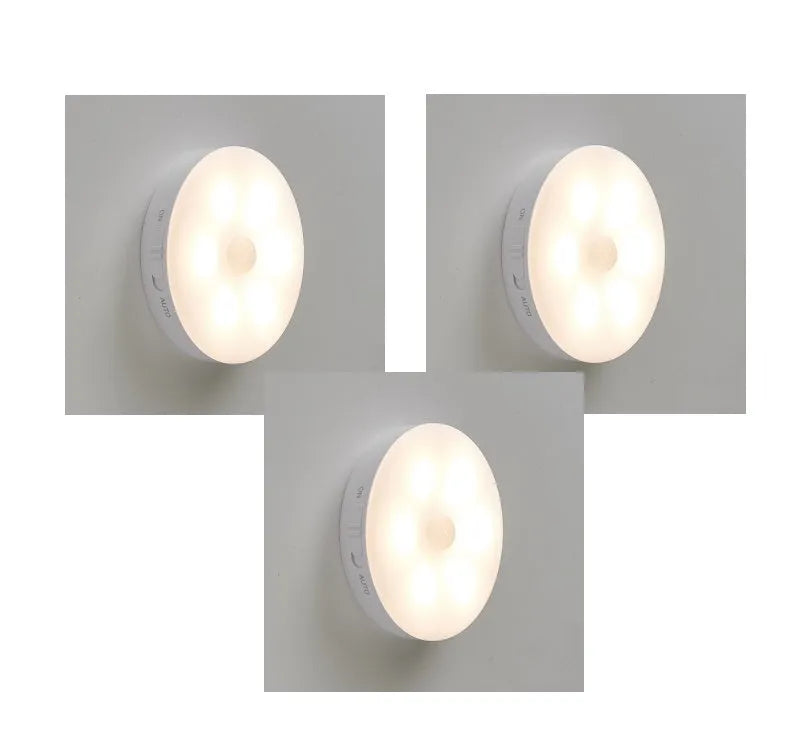 Two wireless motion sensor LED lights mounted inside a wooden cabinet.