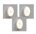 Two wireless motion sensor LED lights mounted inside a wooden cabinet.