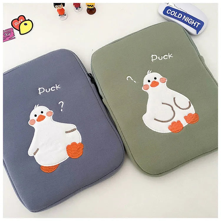 Blue cotton tablet case with a cartoon duck embroidery design and a silver zipper closure.