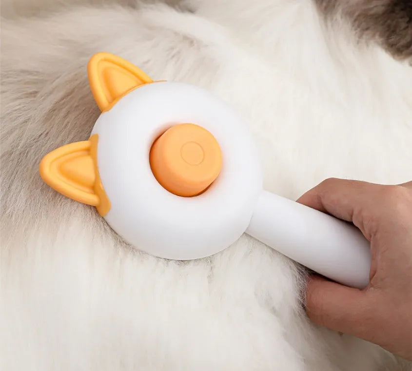 Self-cleaning cat grooming comb in greenish white and orange white colour options