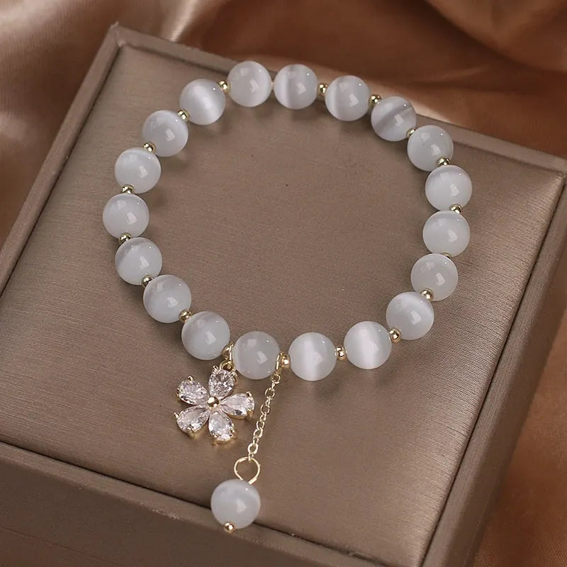 White cat's eye crystal bracelet with floral tassel and morganite safety buckle